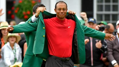 Patrick Reed hands Tiger Woods the Green Jacket after his 2019 Masters victory