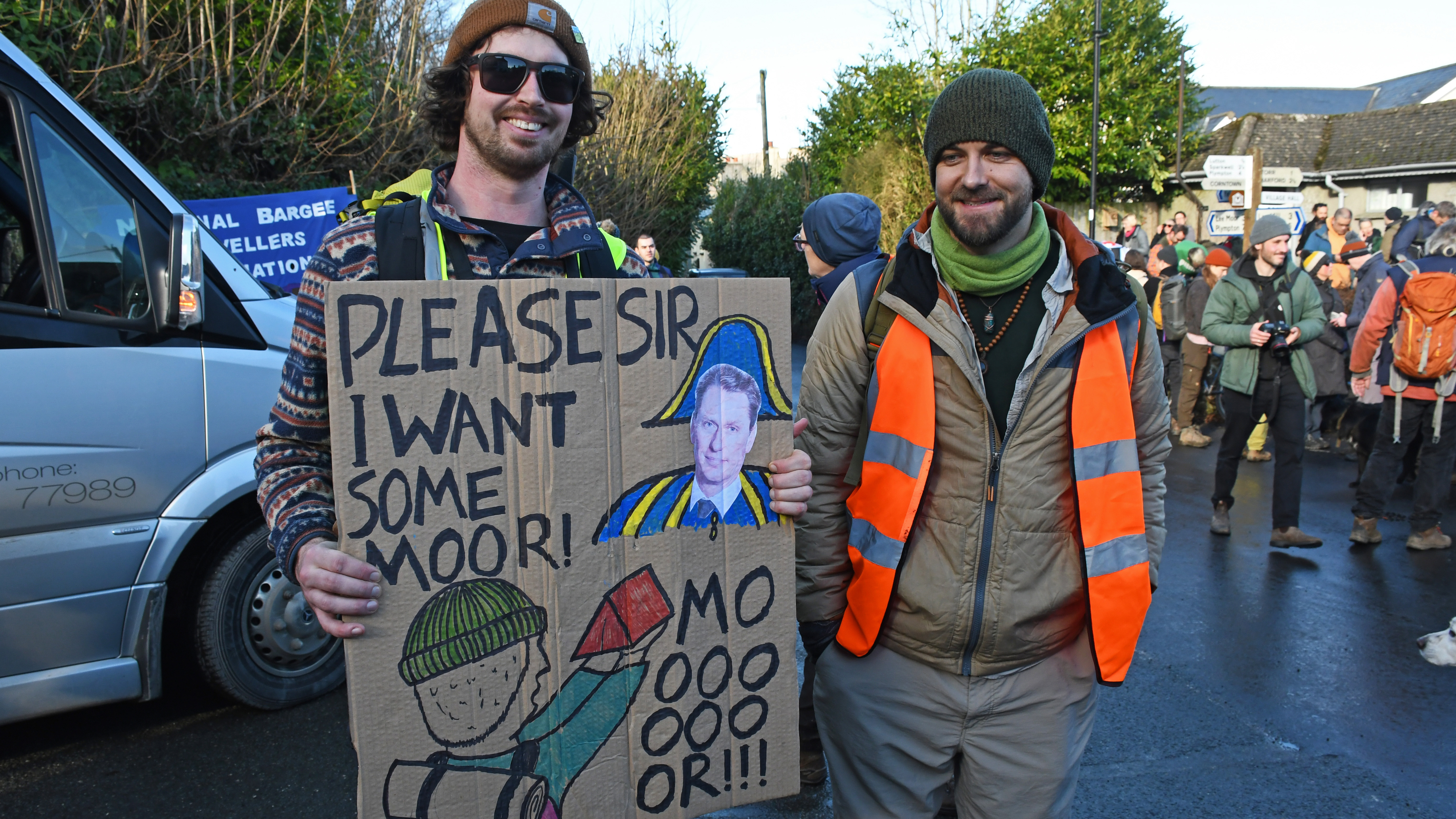 Protesters ahead of a mass gathering in 2023 hold a banner depicting landowner Darwall, with a forlorn-looking wild camper holding a tent and pleading: 'Please Sir, I want some moor…'