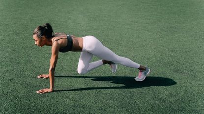 Woman performing plank variations outside