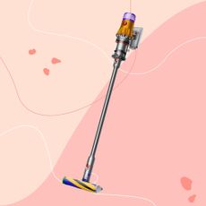 Dyson V12 Detect Slim Absolute on a pink background