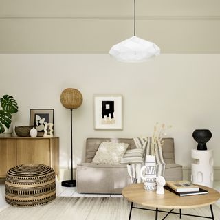 living room ceiling ideas, living room with cream walls and stone coloured ceiling and below picture rail, oatmeal coloured sofa, rug, seagrass footstool, wooden coffee table, sideboard, floor lamp, white pendant light