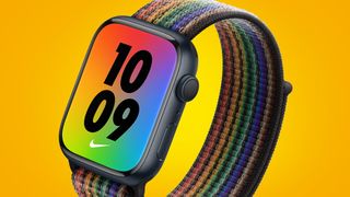 An Apple Watch Series 7 with a multi-colored strap on a yellow background