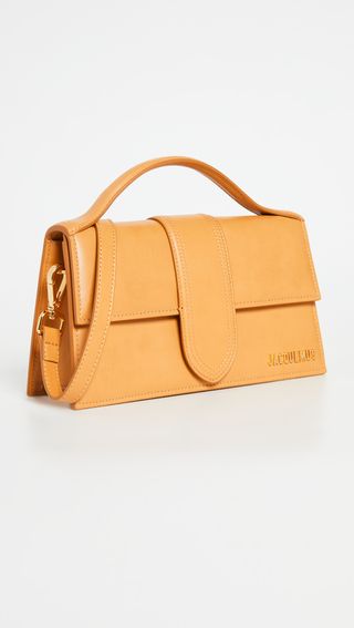 a Jacquemus Le Grand Bambino Bag with a top handle in orange