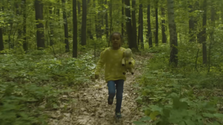 A child running in the woods in Suburban Screams.
