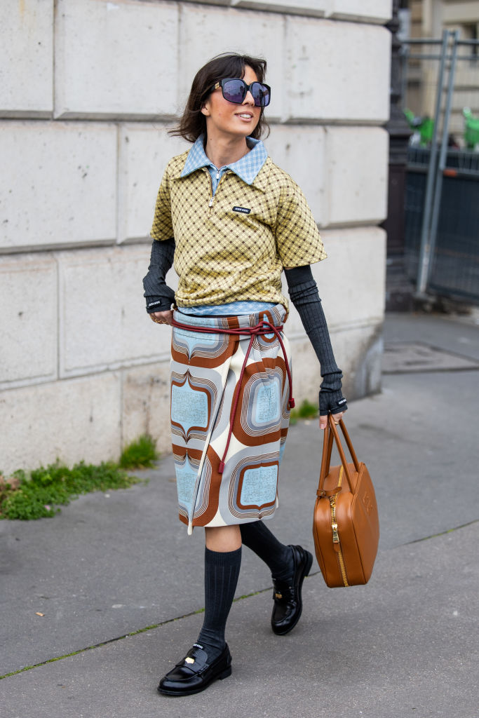 Influencer at fashion week wearing miu miu loafers