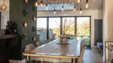 kitchen extension with green wall and pendant lighting