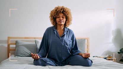woman sitting on bed practicing manifestation before sleep