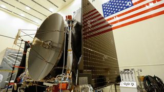 Technicians at a Lockheed Martin Space clean room near Denver, Colorado, install the high gain antenna and solar arrays onto the OSIRIS-REx spacecraft prior to the start of environmental testing.