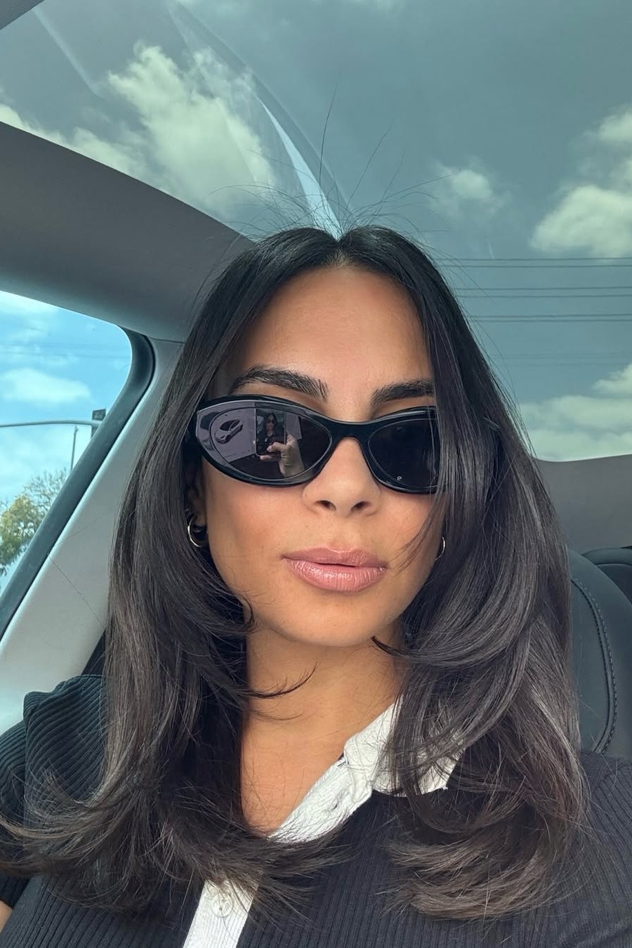 A model with their hair cut in long layers.