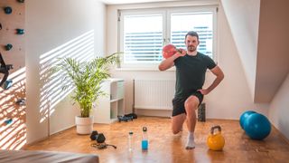 Man works out with kettlebell at home