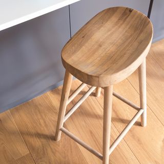 oval shape wooden stool on wooden floor