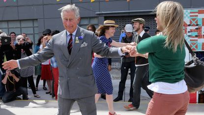 Prince Charles, Prince of Wales dances with Lisa Shannon at the Dance-O-Mat during a visit to Christchurch on November 16, 2012 in Christchurch, New Zealand. The Dance-O-Mat was set up to give people the opportunity to keep dancing after many of the venues were destroyed by the earthquake of 2010. The Royal couple are in New Zealand on the last leg of a Diamond Jubilee that takes in Papua New Guinea, Australia and New Zealand.