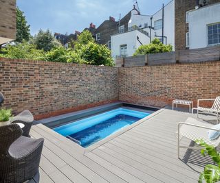 A bijou rectangular swimming pool in a small city garden