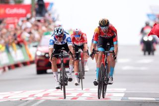GUADARRAMA SPAIN SEPTEMBER 16 LR Remco Evenepoel of Belgium and Team Soudal Quick Step Polka dot Mountain Jersey and Wout Poels of The Netherlands and Team Bahrain Victorious sprint at finish line to win the stage during the 78th Tour of Spain 2023 Stage 20 a 2078km stage from Manzanares El Real to Guadarrama UCIWT on September 16 2023 in Guadarrama Spain Photo by Alexander HassensteinGetty Images