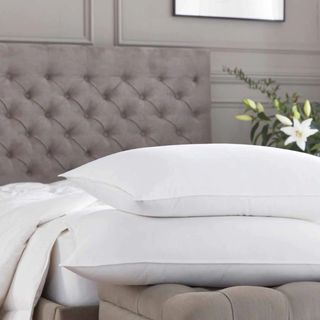 A pair of pillows laid on an upholstered bed