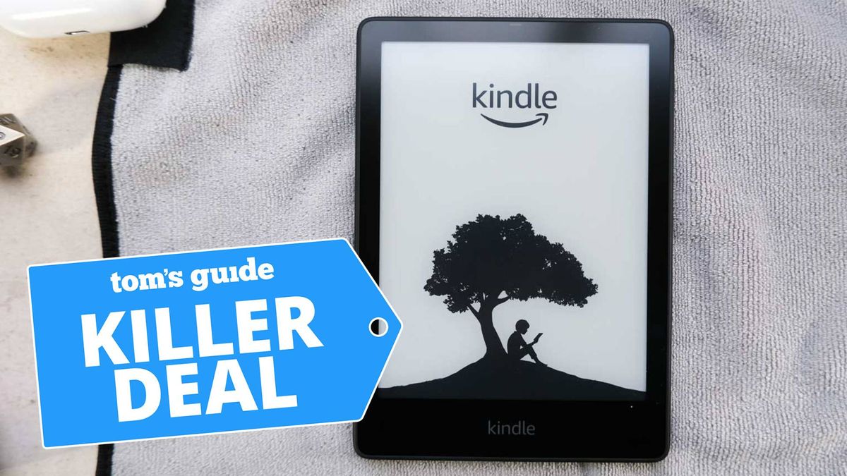 A photo of the Kindle Paperwhite Signature Edition tablet laying on a white towel. The &quot;Tom&#039;s Guide killer deal&quot; tag is overlaid.