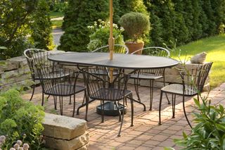 A small patio with a modern black table and chairs.