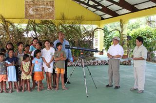 Eclipse chasers Imelda Joson and Edwin Aguirre help donate a telescope to a school on on Tatakoto Atoll in French Polynesia after 2010 total solar eclipse.