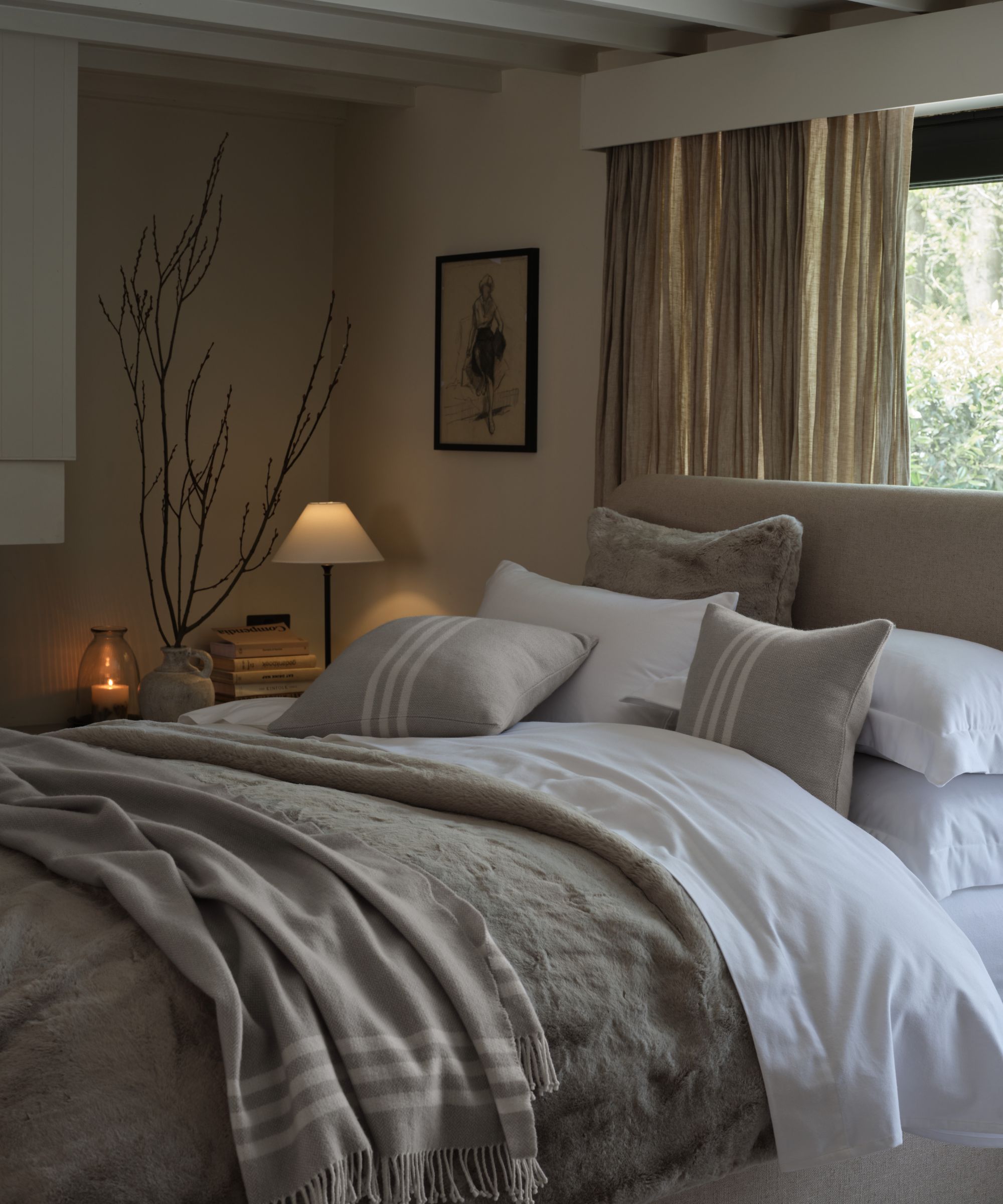The White Company white bedding layered cushions and throws