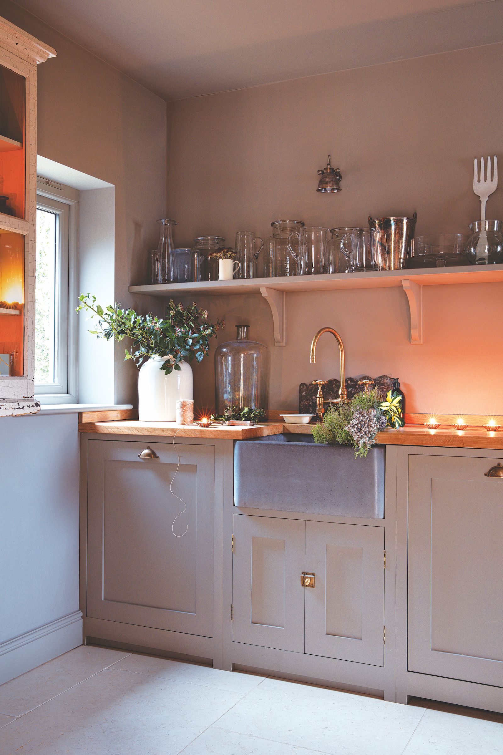oak frame house utility room with butler sink and painted cabinets