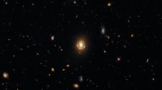 The Einstein ring shows light from a distant quasar being bent around two galaxies 3.4 billion light-years away.