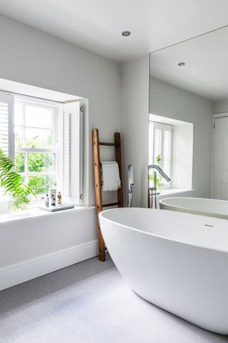 renovated bathroom with deep window cill and freestanding bath