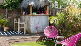 garden party idea with tiki bar and pink garden chairs