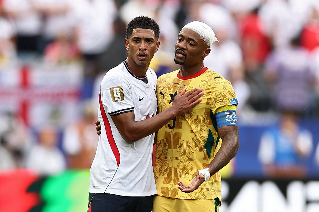 Jude Bellingham and Jordan Ayew embrace during England vs Ghana