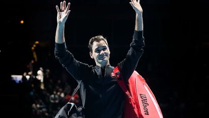 Roger Federer waves to the crowd after his victory against Novak Djokovic 