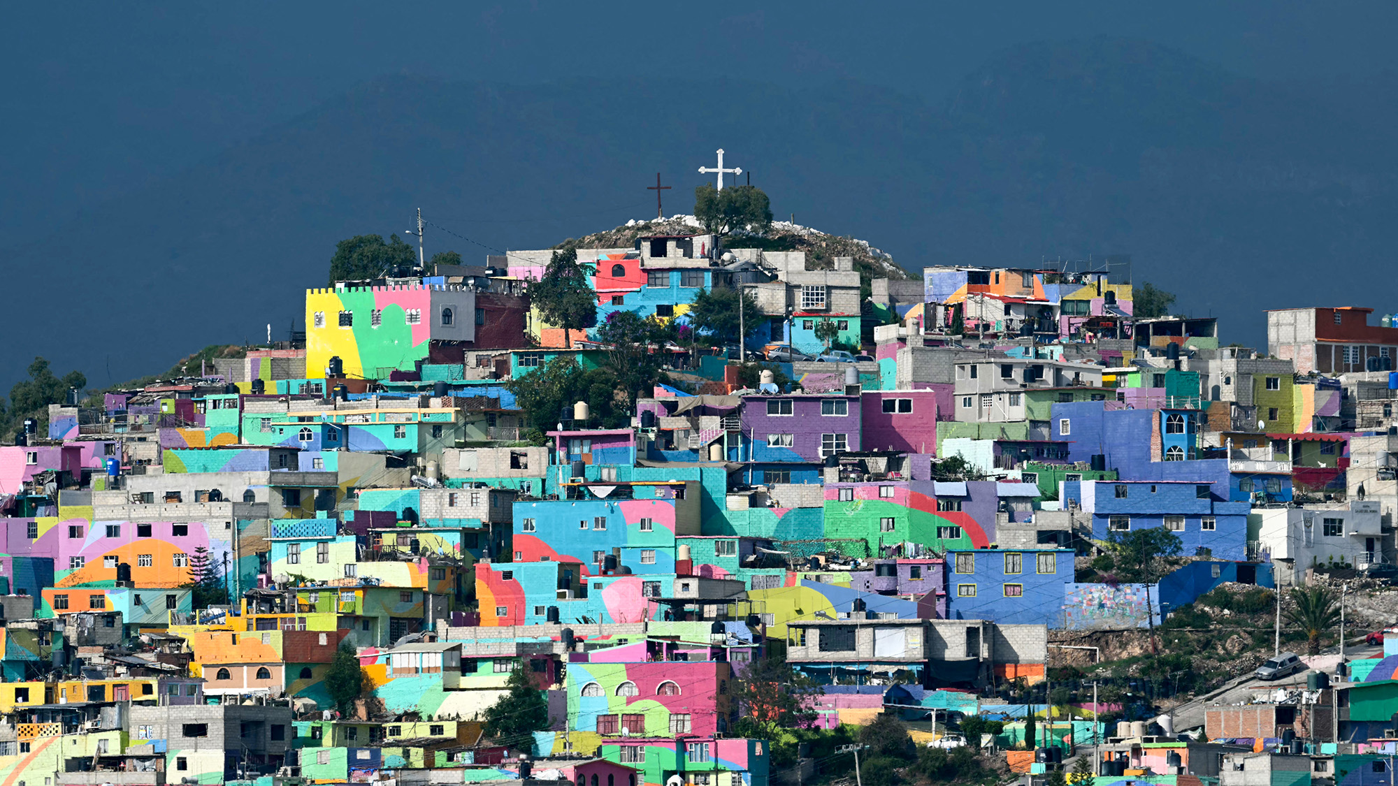 Dozens of houses that make up the Macromural artwork are seen on a hill in Pachuca, Mexico