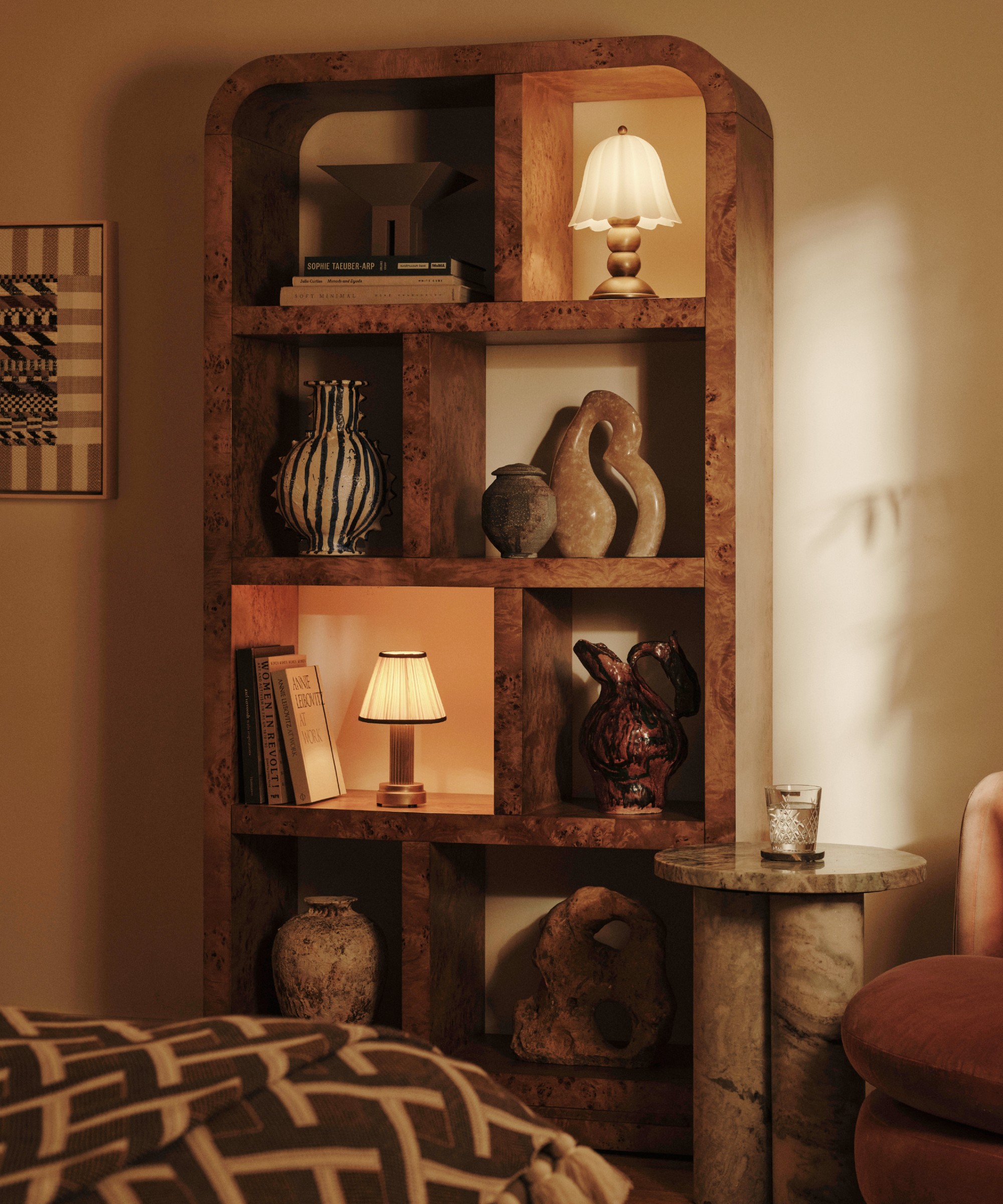 Soho Home's Wallace Shelves in burl wood veneer filled with table lamps, books and sculptural decor