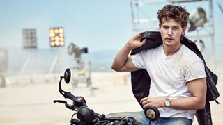 Breitling ambassador, Austin Butler, wearing the new Breitling Top Time watch while riding a motorcycle.