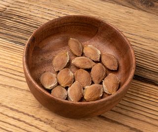 fruit pits in a wooden bowl