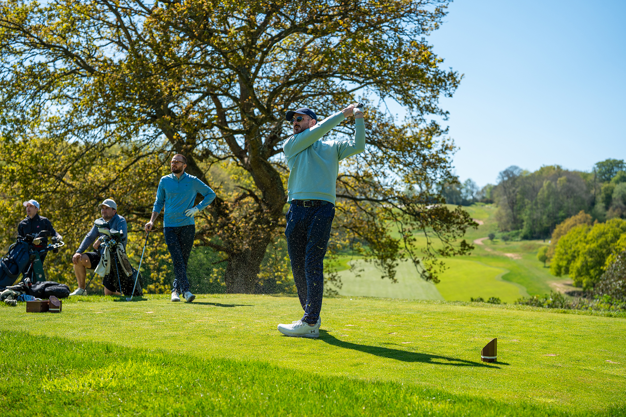 Baz Plummer playing golf with three other players