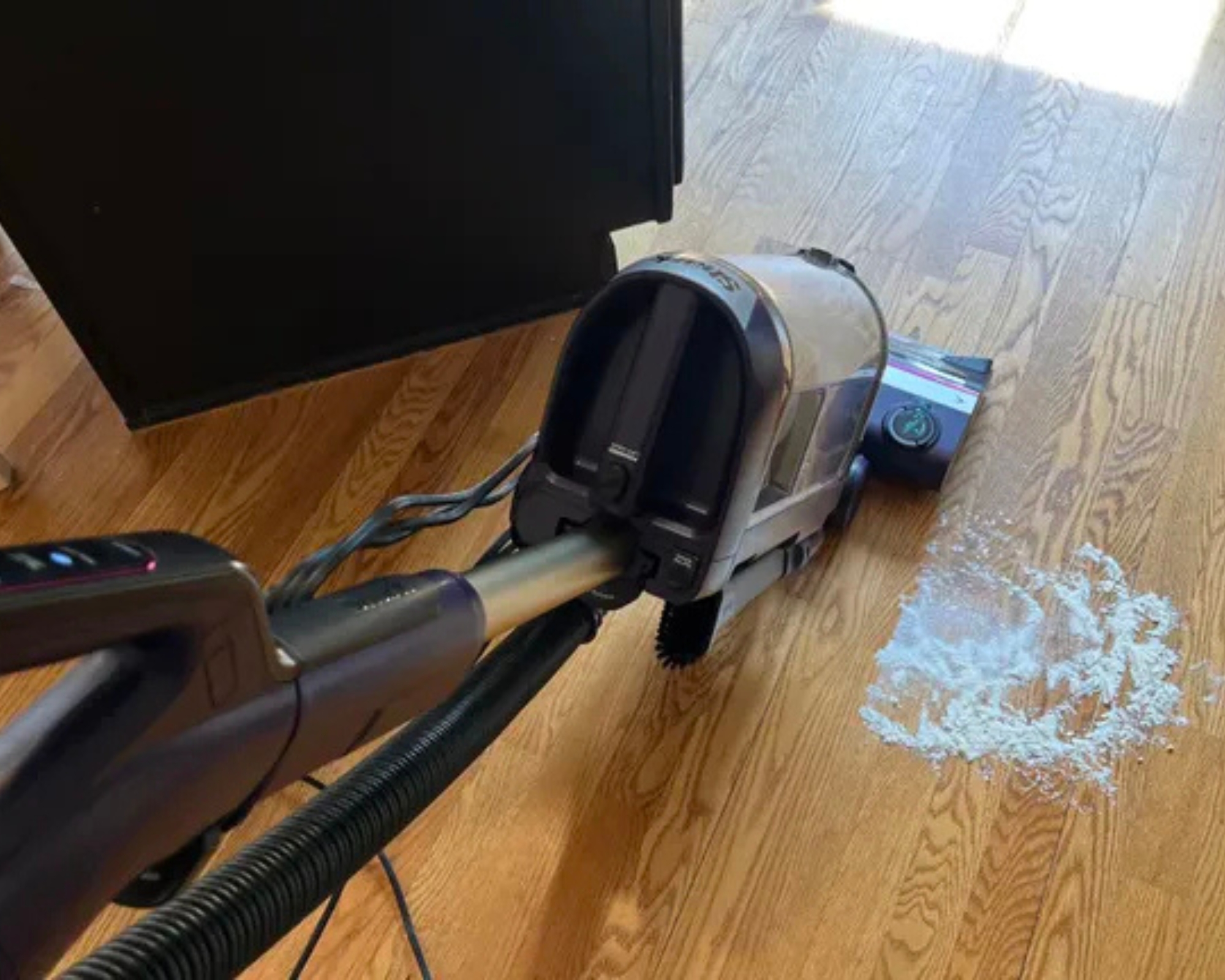 Shark POWERDETECT Upright Vacuum vacuuming flour and sugar on wooden floor