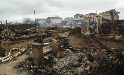 Homes sit smoldering in the Breezy Point neighborhood of Queens, N.Y. Some 100 homes there burned down in a fire during the storm. 