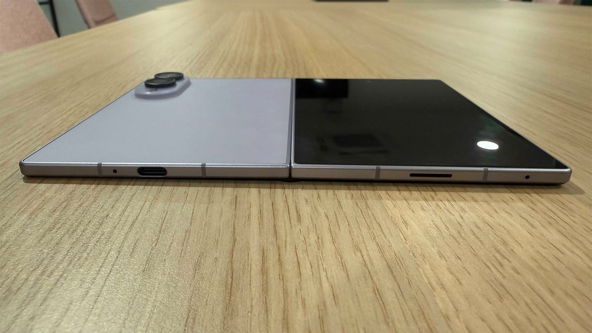 Samsung Galaxy Z Fold 8 smartphone unfolded lying flat on wooden table