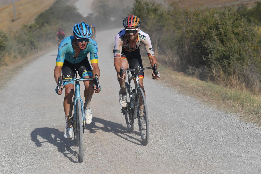 SIENA ITALY AUGUST 01 Jakob Fuglsang of Denmark and Astana Pro Team Maximilian Schachmann of Germany and Team BoraHansgrohe Dust Gravel Strokes during the Eroica 14th Strade Bianche 2020 Men a 184km race from Siena to SienaPiazza del Campo StradeBianche on August 01 2020 in Siena Italy Photo by Tim de WaeleGetty Images