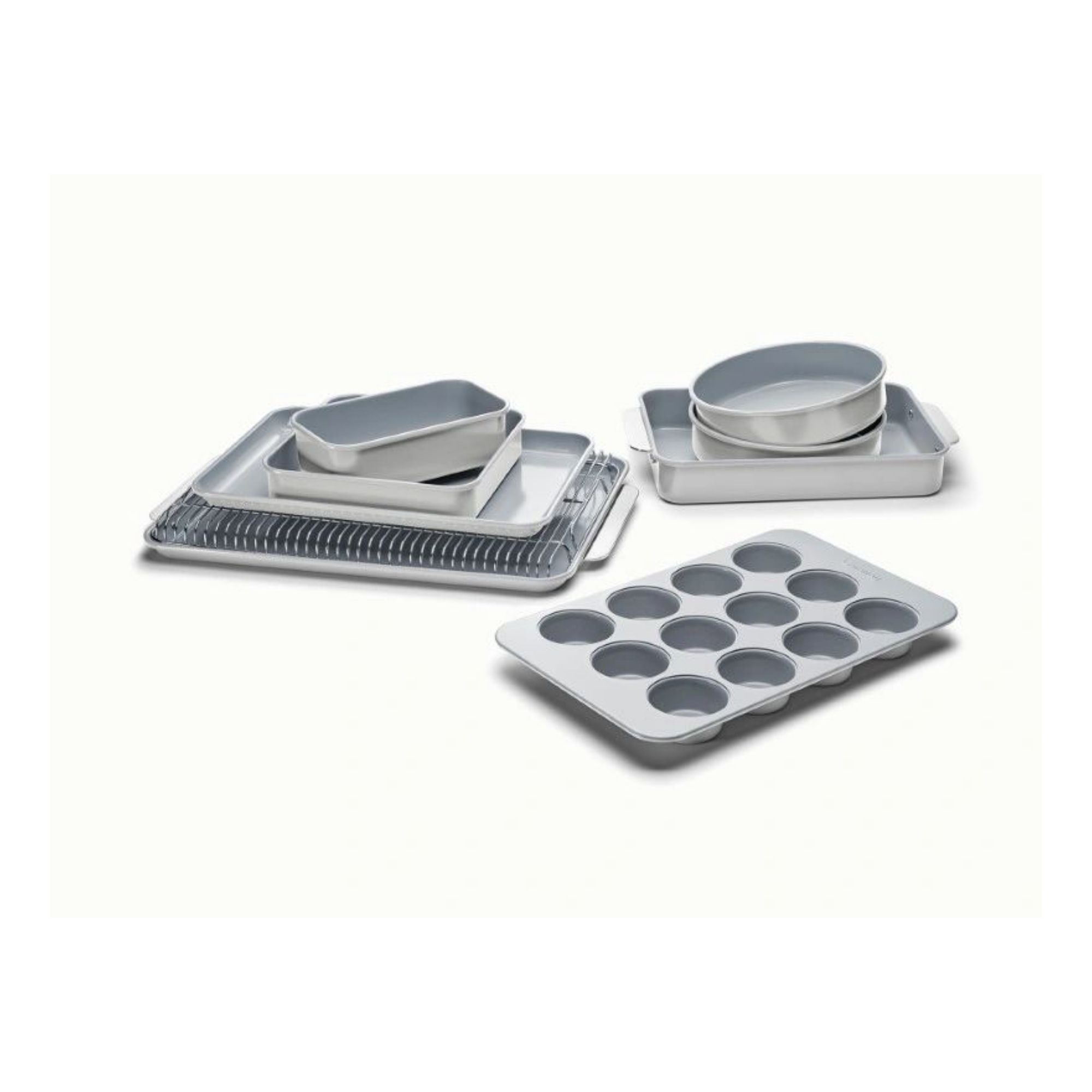 A complete set of cream bakeware, including baking trays, cake tins, roasting tin, muffin tin, and a loaf tin.