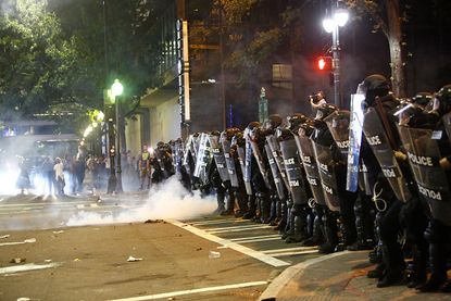 Police with shields in Charlotte, North Carolina.