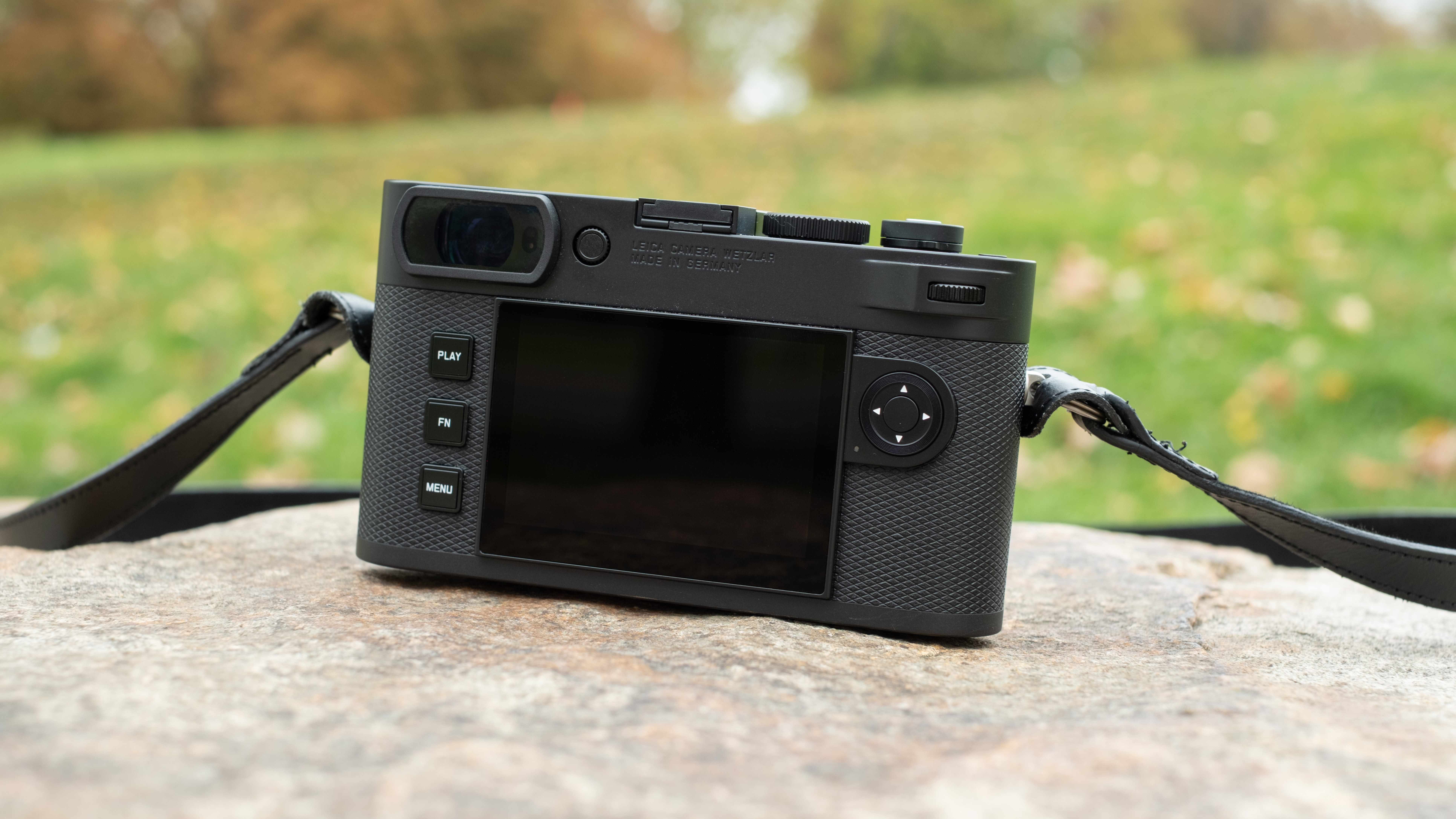 Leica M EV1 digital camera with lens attached on a stone surface