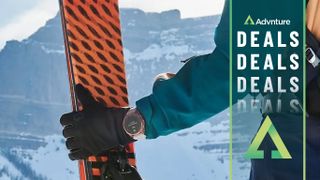 Woman holding skis wearing Garmin Fenix 7S Sapphire Solar watch