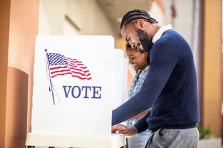 A man at a voting booth