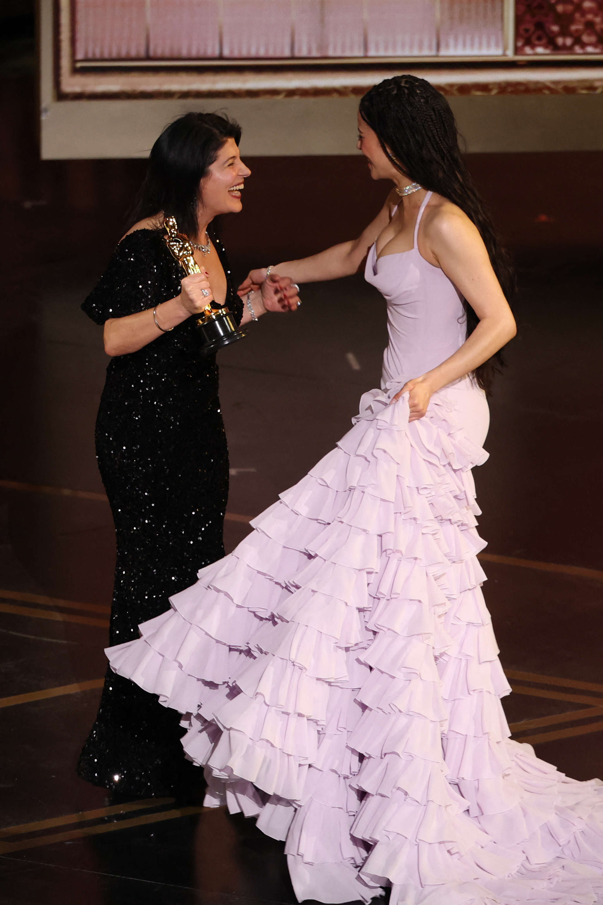 US actress Chase Infiniti (R) cheers for US casting director Cassandra Kulukundis, winner of the Best Casting Oscar for "One Battle After Another" onstage during the 98th Annual Academy Awards at the Dolby Theatre in Hollywood, California on March 15, 2026