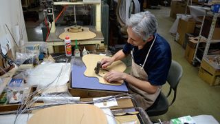  A craftsman carefully fits the rosette around the soundhole of a cutaway acoustic in Takamine’s Japanese factory in Sakashita. Far from being an anonymous, highly mechanised operation, a wealth of traditional craft skills go into each guitar