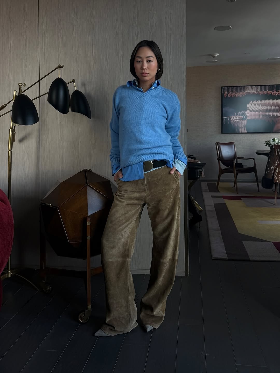 Aimee Song wearing blue jumper, suede trousers and kitten heels.
