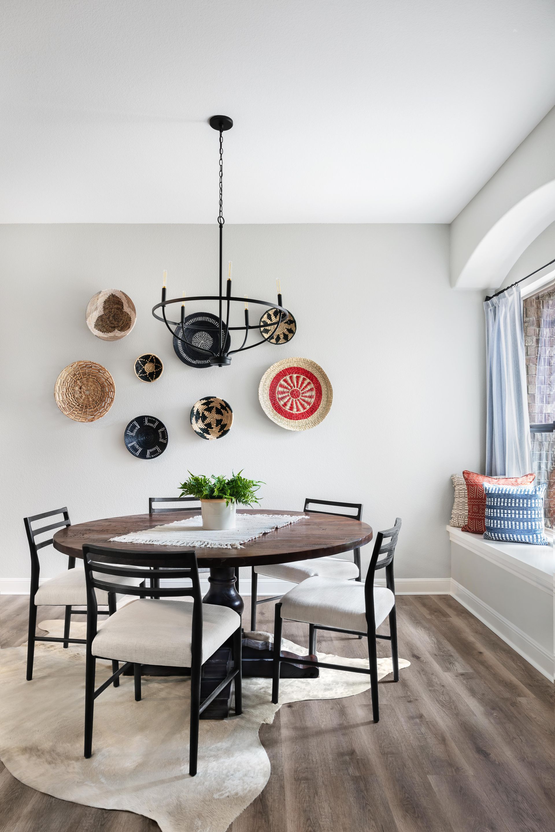 Dining rom with black dining et and plates used to decorate the walls