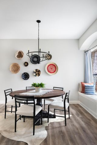 Dining rom with black dining et and plates used to decorate the walls