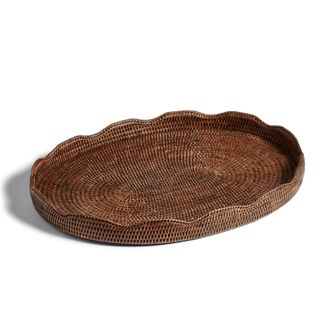 A decorative scalloped rattan tray