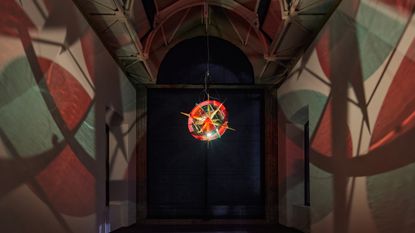 installation view of hanging sculpture with light inside